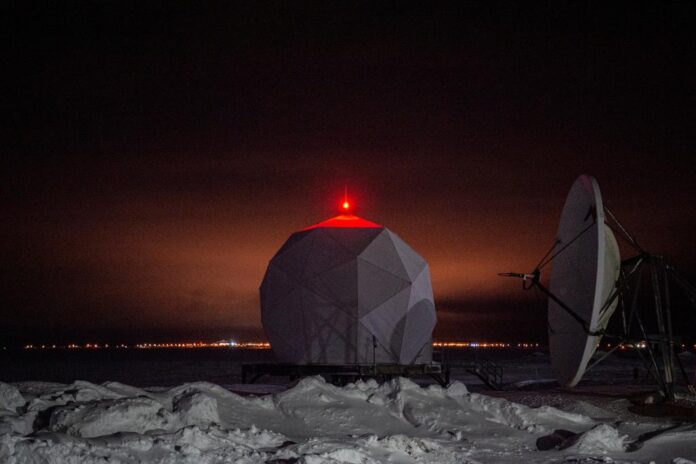 A radar dome is illuminated at the North American Aerospace Defense Command (NORAD) Point Barrow Long Range Radar Site, north of the northernmost town in the United States in Utqiagvik, Alaska, on Feb. 3, 2023. via REUTERS