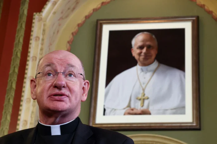 Richard Moth, newly appointed as Archbishop of Westminster, speaks next to a portrait of Pope Leo XIV during a press conference at the Archbishop's House, in London, Britain, December 19, 2025. REUTERS/Toby Melville