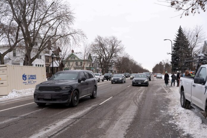 Rapid response community observers honk and shout at a vehicle carrying federal agents during an immigration raid on a home in the South Minneapolis area, in Minneapolis, Minnesota, U.S. December 4, 2025. REUTERS/Tim Evans