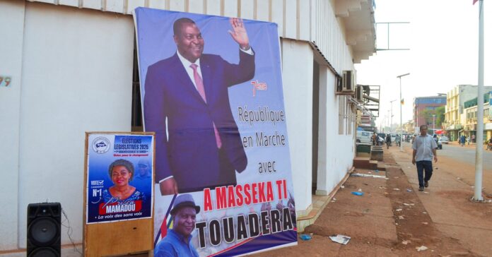 A man walks past a campaign billboard of President and presidential candidate Faustin-Archange Touadera, ahead of the presidential election scheduled for December 28, in Bangui, Central African Republic December 24, 2025. REUTERS/Leger Serge