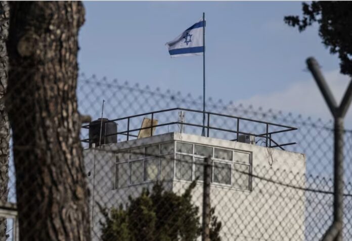 Israeli army carries out a raid, and replaces the UN flag with the Israeli flag at the UNRWA center in east Jerusalem on Monday, December 08.  Mostafa Alkharouf/Anadolu/Getty Images