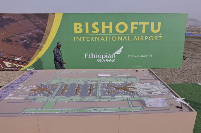 A member of the Ethiopian Federal Police walks past the Bishoftu International Airport design during its construction commencement in Abusera, Ethiopia, January 10, 2026. REUTERS/Tiksa Negeri 