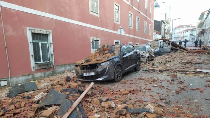Cars are seen damaged after a building's roof collapsed on them during the passage of storm Kristin in Figueira da Foz, Portugal, Wednesday, Jan. 28, 2026. (Figueira Na Hora/Jorge Lemos via AP) (AP)