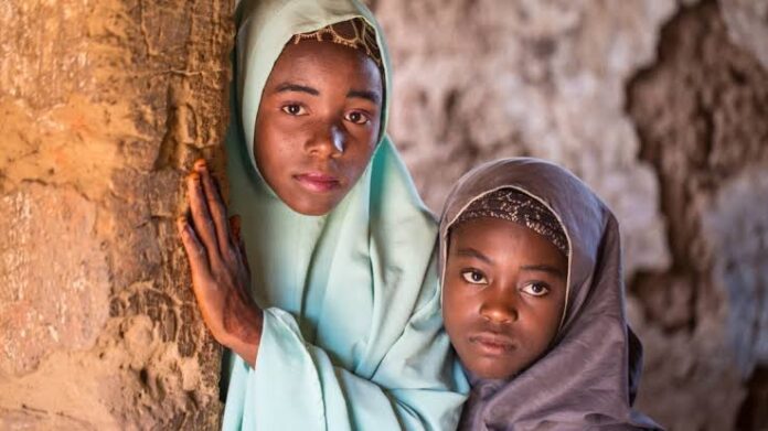 Aisha Amiru (with green hijab) said she and her younger sister look forward to getting married in a few years. (C. Oduah/VOA)