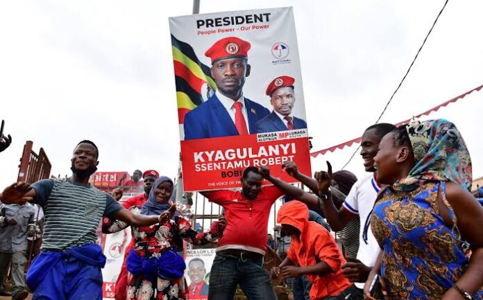 Supporters of Ugandan opposition Presidential candidate Robert Kyagulanyi also known as Bobi Wine dance along the streets ahead of the presidential and parliamentary elections, in Kampala, Uganda January 12, 2021. REUTERS/Abubaker Lubowa