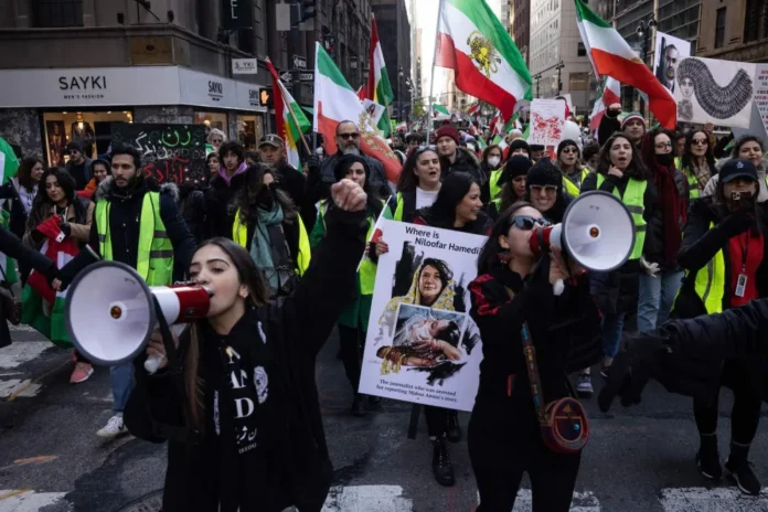 Protesters call on the United Nations to take action against the treatment of women in Iran during a demonstration in New York on Nov. 19. YUKI IWAMURA/AFP via Getty Images