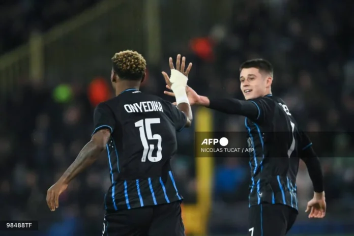 Club Brugge’s Nigerian midfielder #15 Raphael Onyedika celebrates scoring his team’s first goal during the UEFA Champions League knockout round play-off first leg football match between Club Brugge and Atletico Madrid at the Jan Breydel Stadium in Brugge on February 18, 2026. (Photo by NICOLAS TUCAT / AFP)