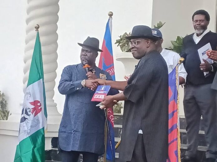 The lawmaker representing Bayelsa West Senatorial District, Senator Seriake Dickson, recieving the NDC Constitution. Photo: Senator Seriake Dickson Media Office