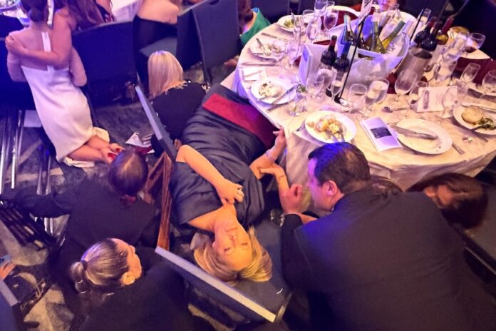 Guests take cover after hearing gunshots at the White House correspondents' dinner. (Reuters: Evan Vucci)