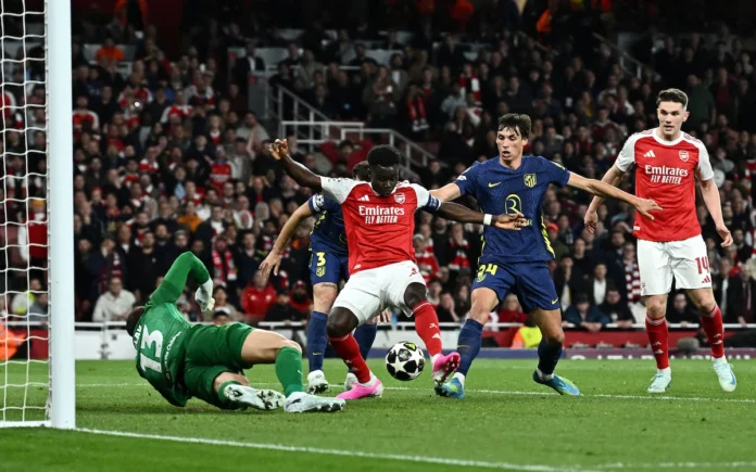 Soccer Football - UEFA Champions League - Semi Final - Second Leg - Arsenal v Atletico Madrid - Emirates Stadium, London, Britain - May 5, 2026 Arsenal's Bukayo Saka scores their first goal past Atletico Madrid's Jan Oblak REUTERS/Dylan Martinez