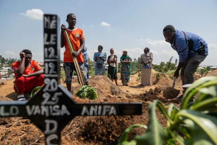 Relatives of Vanisa Anifa, a 6-month-old orphaned girl who died of Ebola, attend her burial, in Bunia, Congo, Friday, June 19, 2026. (AP Photo/Moses Sawasawa)
