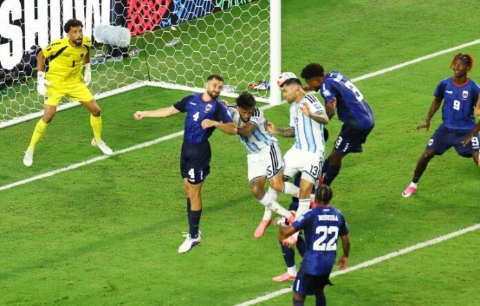 Argentina’s Cristian Romero scores their third goal [Marco Bello/Reuters]
