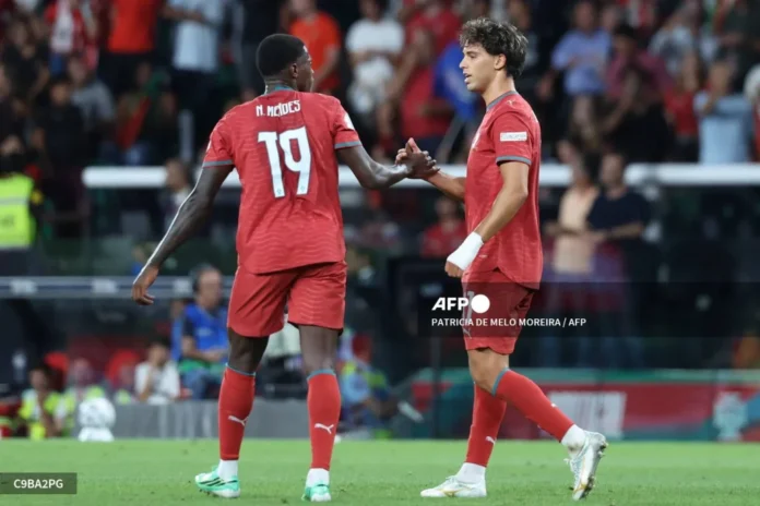 Portugal's forward #11 Joao Felix celebrates with teammate defender #19 Nuno Mendes after scoring his team's first goal during the UEFA Nations League league phase group A4 football match between Portugal and Wales at Jose Alvalade stadium in Lisbon on September 24, 2026.